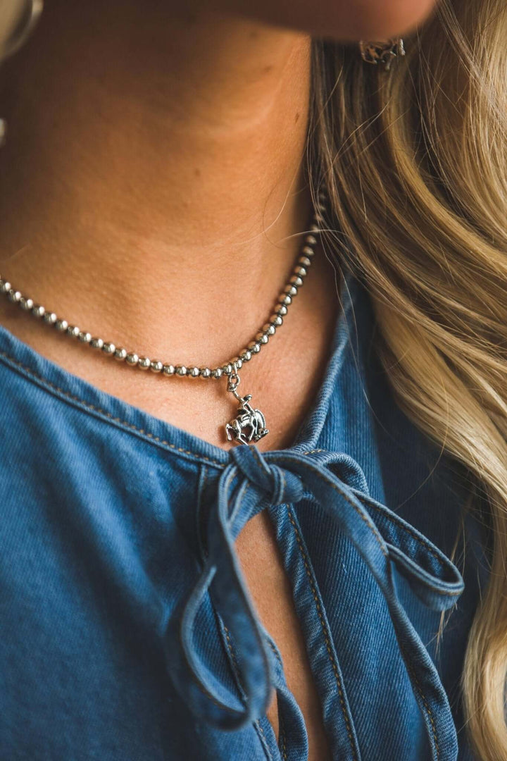 Gold-plated burnished necklace with bucking horse pendant, 16 inches long, by West & Co.