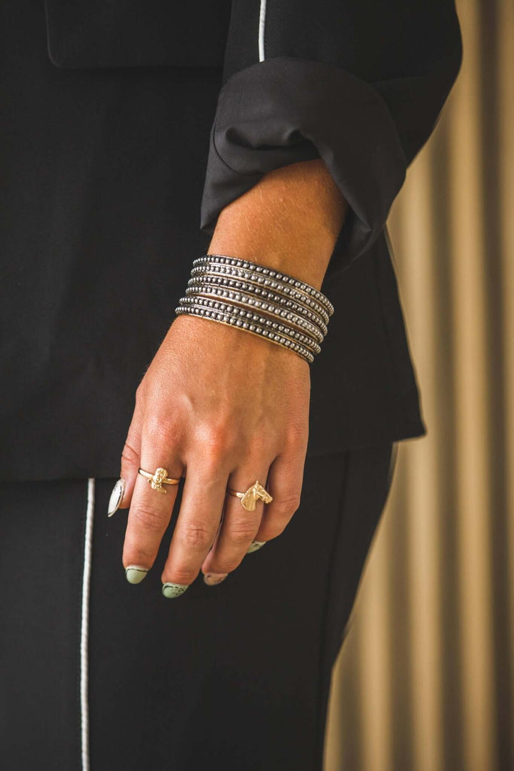 West & Co. 18K plated dotted bangle set featuring multiple sleek bangles with dotted detailing for elegant wrist accessories.