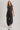 Washed black sleeveless jogger jumpsuit by blueivy, relaxed fit with drawstring waist, styled as a casual skirt one-piece.
