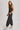 Washed black sleeveless jogger jumpsuit by Blueivy, relaxed fit with drawstring waist, featuring a skirt design and casual style.