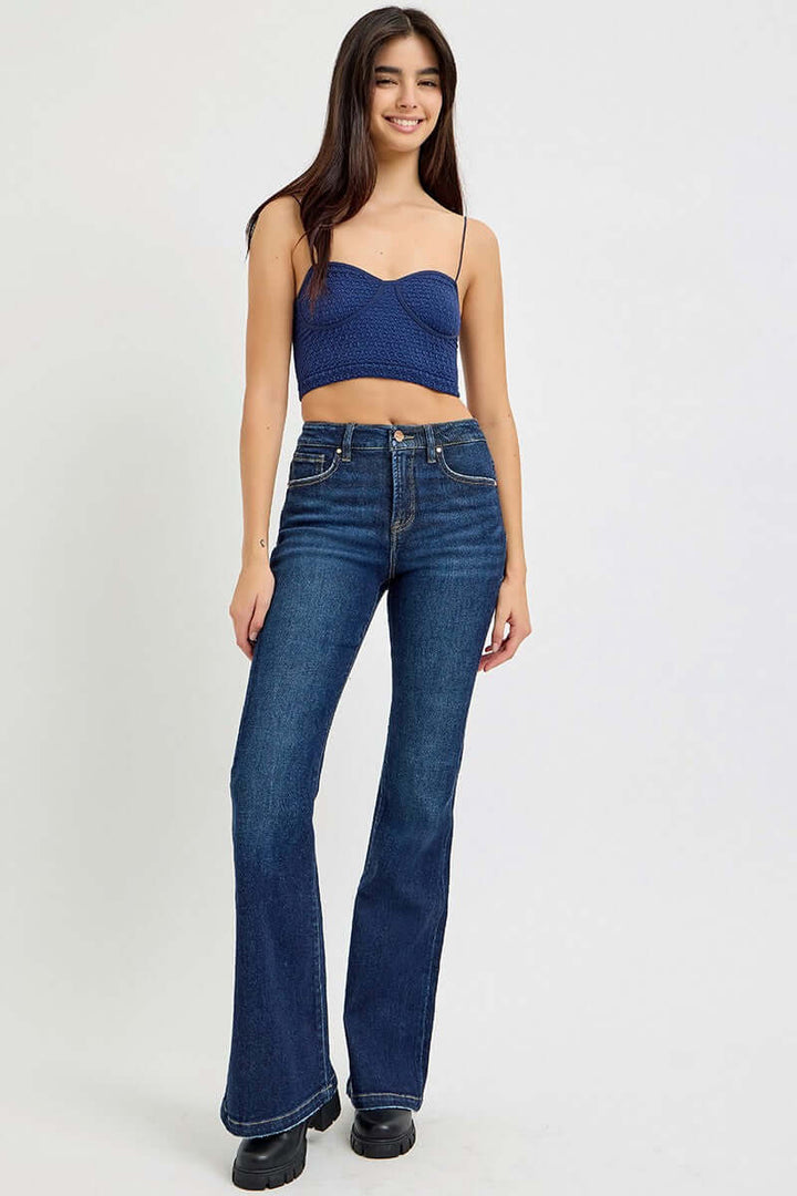 Risen denim tummy control high-rise flare jeans with a fitted waist and flared legs, shown in a front view.