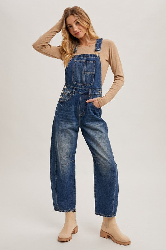 Women’s blue denim barrel overalls with wide-leg fit, relaxed bib design, by blueivy, displayed on a hanger.