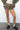 TICTOC Bayou Dark Camo Cloud Fleece Mini Skort showing the camouflage pattern, fleece fabric, and skirt silhouette.