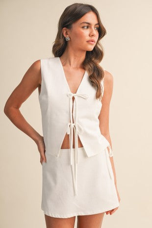 Klesis linen front tie sleeveless top and wrap skort set, showcasing light fabric, front tie detail, and stylish wrap design.