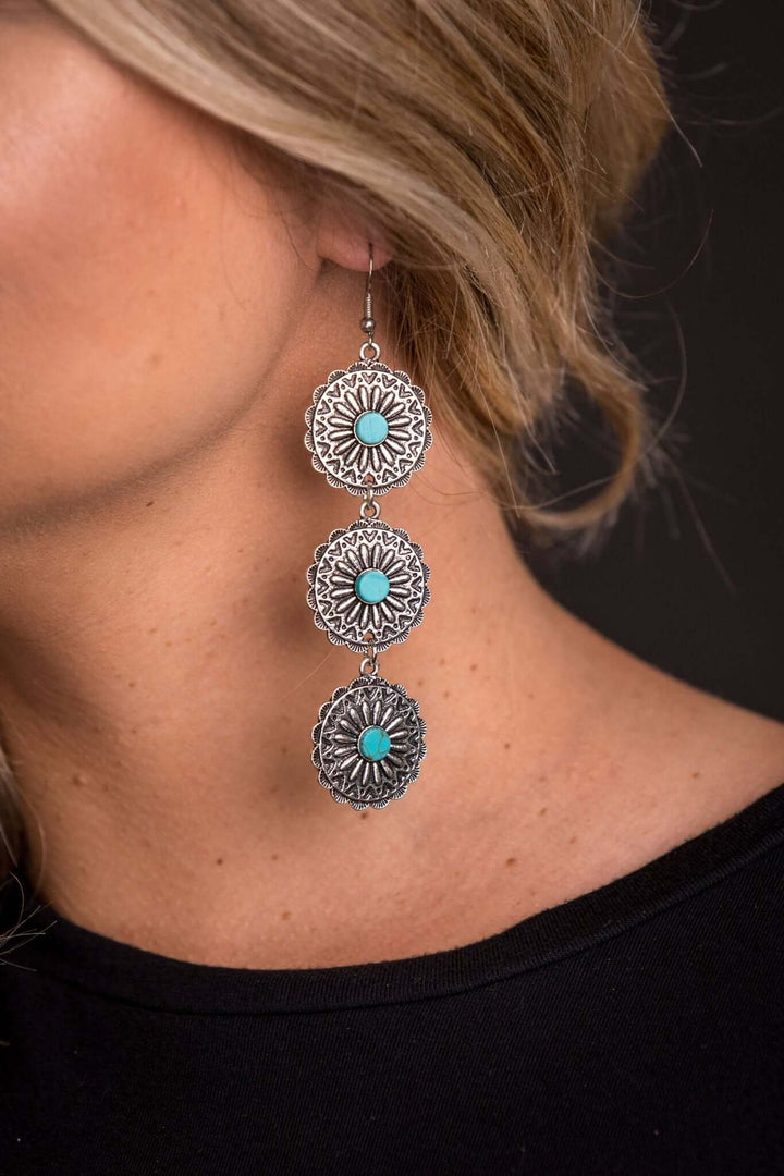 West & Co. 3-tier burnished silver and turquoise floral concho earrings showing intricate designs and vibrant turquoise accents.