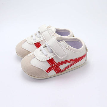 Off white infant tennis shoes with red design
