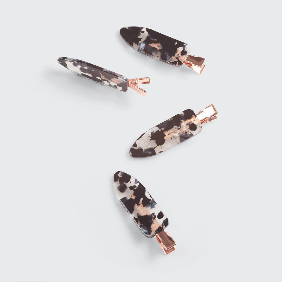 Set of four black terrazzo creaseless clips by KITSCH for securing hair, featuring eco-friendly design and durable plastic material.
