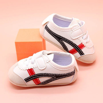 Off white infant tennis shoes with red & black