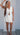 Klesis linen front tie sleeveless top and wrap skort set, lightweight and stylish summer outfit with neutral tones.
