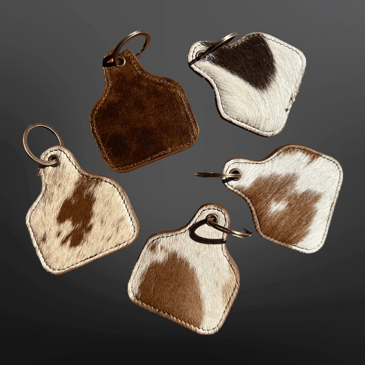 Cow Tag-shaped leather cowhide keychain from Westrian International featuring natural leather texture and detailed craftsmanship.