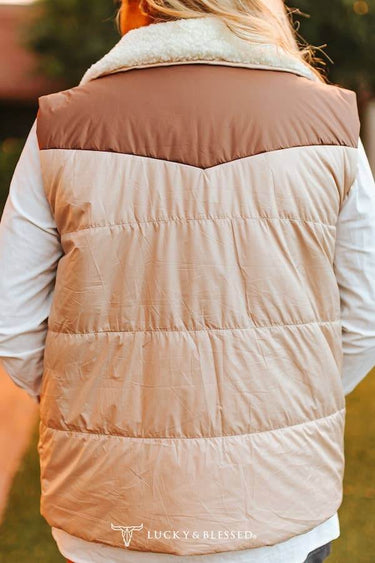 Cream puffer vest by Lucky & Blessed with camel yoke and sherpa-lined neckline, shown on a model.