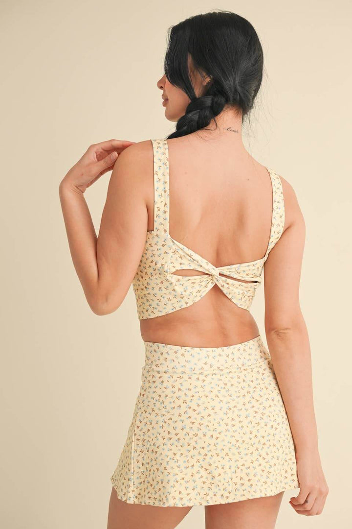 Ditsy print twist-back crop tank top by KIMBERLY C featuring a sleeveless design and stylish twisted back detail.