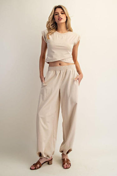 Ee:some sleeveless crop top paired with elastic-waist lounge pants in a comfortable loungewear set.