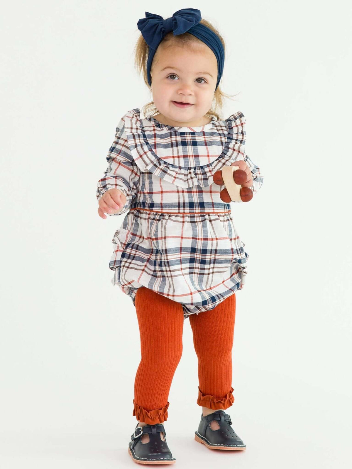 Girls Rust Rib Knit Footless Ruffled Tights from RuffleButts + RuggedButts, featuring a ribbed knit design and ruffled accents.