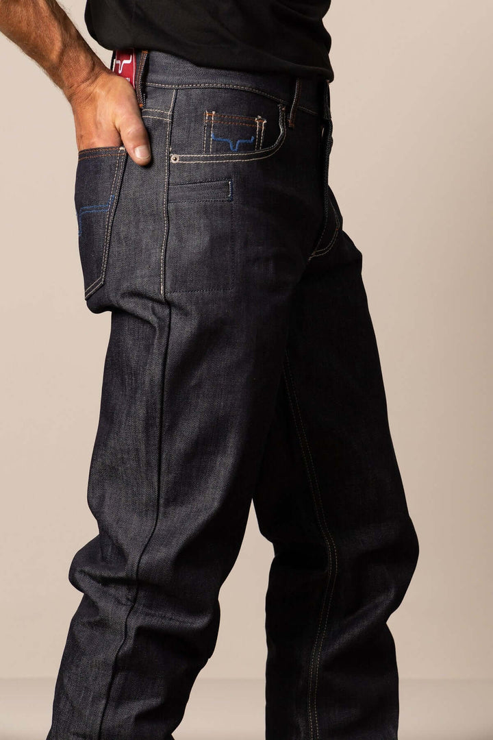 Kimes Dillon Raw Jeans, classic denim bottoms with a fitted cut, featuring a dark wash and subtle stitching details.