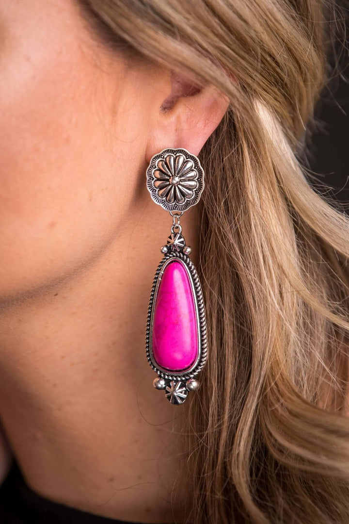 Pink statement earring on silver concho post by West & Co., featuring bold pink design with silver accents.
