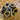 Star-shaped lapel pin resembling a shotgun shell, designed by Brand Dandee, with detailed metallic finish and star motif.