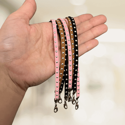 Leather hat chain with metal studs attached to a stylish accessory by Brand Dandee, designed to enhance hat appearance.