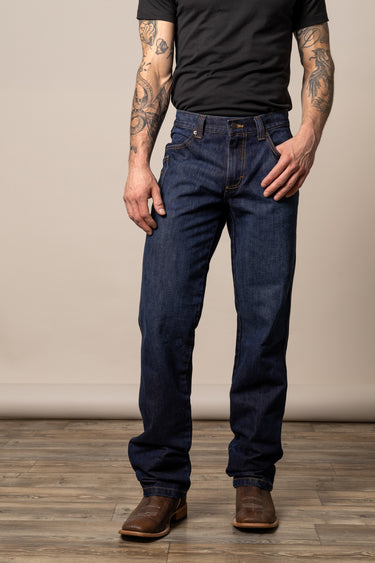 Kimes Ranch Watson men's dark wash relaxed bootcut jeans made of denim, shown hanging on a wooden background.