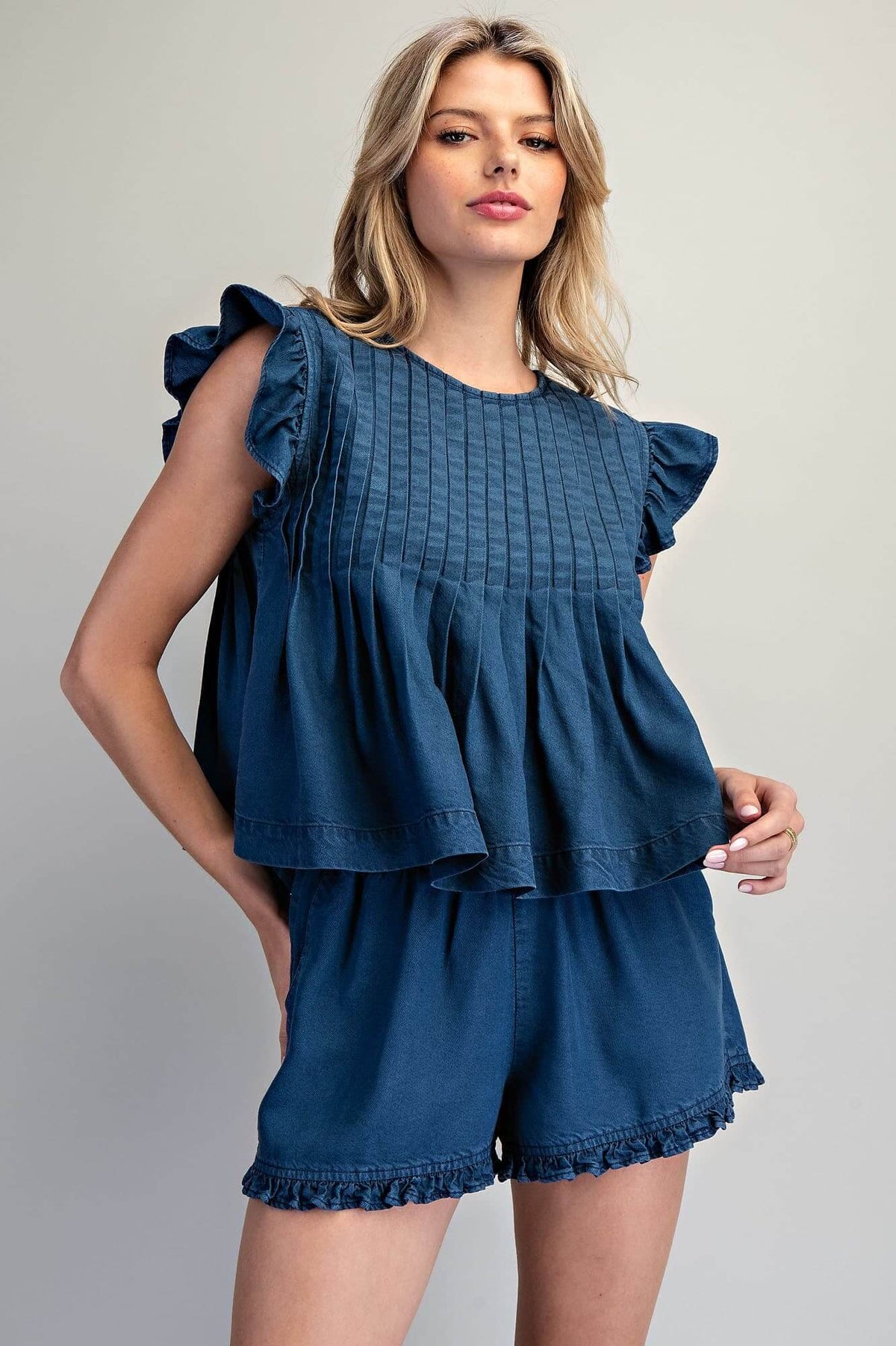 ee:some ruffled hem pintuck pleated peplum blouse image showing feminine details and elegant design in soft fabric