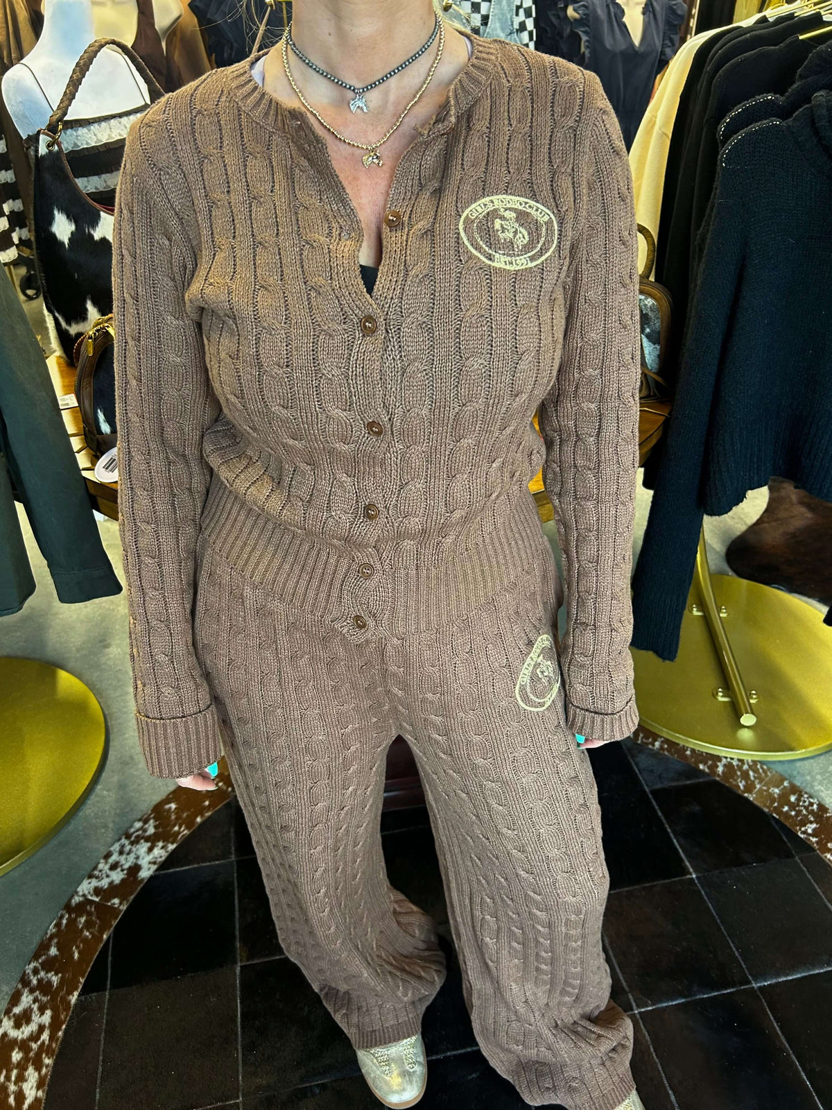 Bailey Rose cable knit cardigan with rose pattern, long sleeves, and button front, displayed on a neutral background.