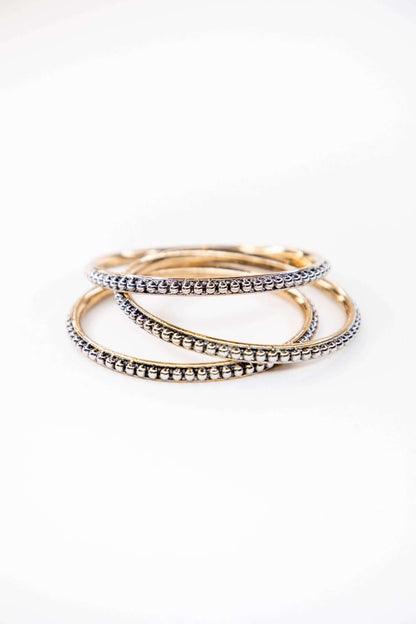 West & Co. 18K plated dotted bangle jewelry set featuring multiple slim bangles with dotted details.