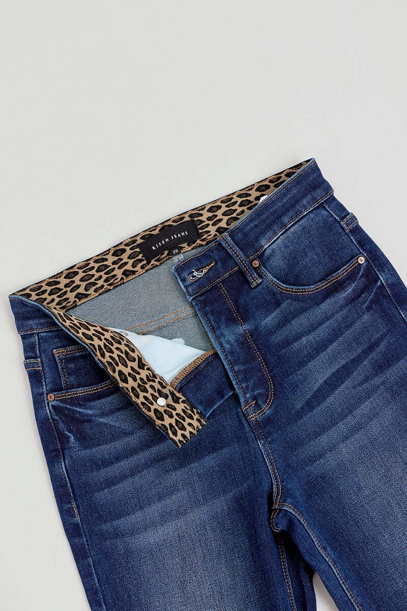 Risen Tummy Control High Rise Flare Jeans with elastic waistband, showcasing a fitted waist and flowing flare leg design.