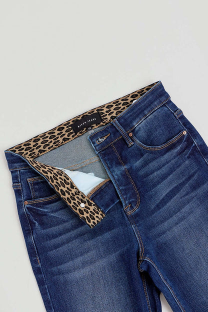 Risen Tummy Control High Rise Flare Jeans with elastic waistband, showcasing a fitted waist and flowing flare leg design.
