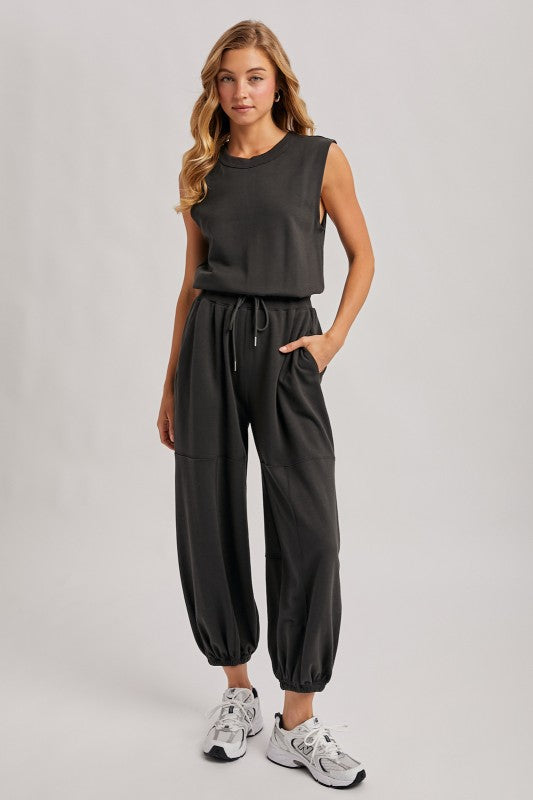 Washed black sleeveless jogger jumpsuit by blueivy featuring a relaxed fit, drawstring waist, and casual skirt style.