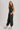 Washed black sleeveless jogger jumpsuit from blueivy featuring relaxed fit, drawstring waist, and skirt-style design.