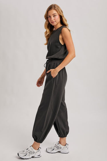 Washed black sleeveless jogger jumpsuit by Blueivy, relaxed fit with drawstring waist, featuring a skirt design and casual style.