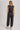 Washed black sleeveless jogger jumpsuit by blueivy featuring relaxed fit, drawstring waist, and casual skirt-style design.