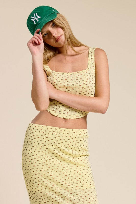 Mimosa floral print corset-fitted tank top and matching skirt set displayed on a model, showcasing a vibrant, summery fashion look.