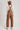 Women's brown barrel leg overalls by blueivy, Western-style cowgirl jumpsuit with pocket details and adjustable straps.