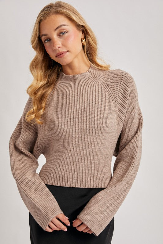 Blueivy mock neck open back tie sweater shown on a model, featuring a stylish neckline and back tie detail.