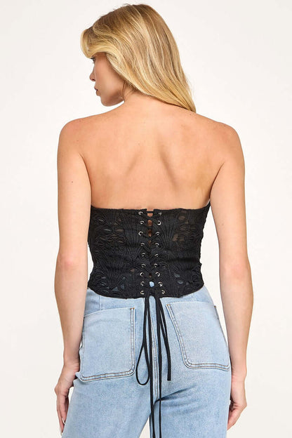 Cutwork corset top from The Vintage Shop featuring intricate embroidery and a fitted design, displayed on a white background.