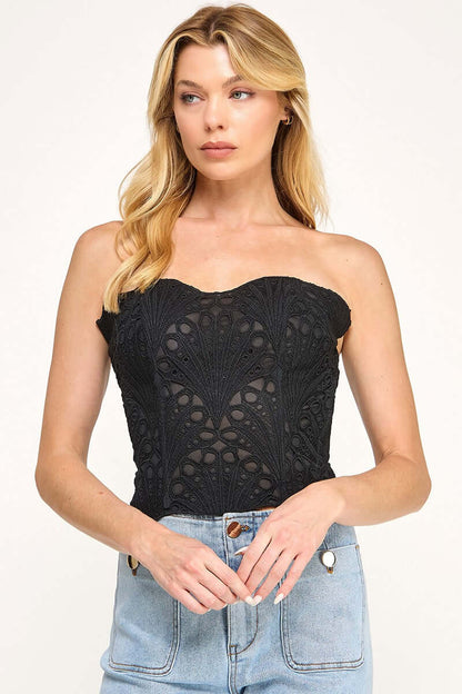 Cutwork corset top from The Vintage Shop featuring intricate lace details and a fitted design, shown on a neutral background.