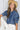 Women's chambray puff sleeve button-up blouse by Vine and Love, Western denim top with tied collar and long sleeves.