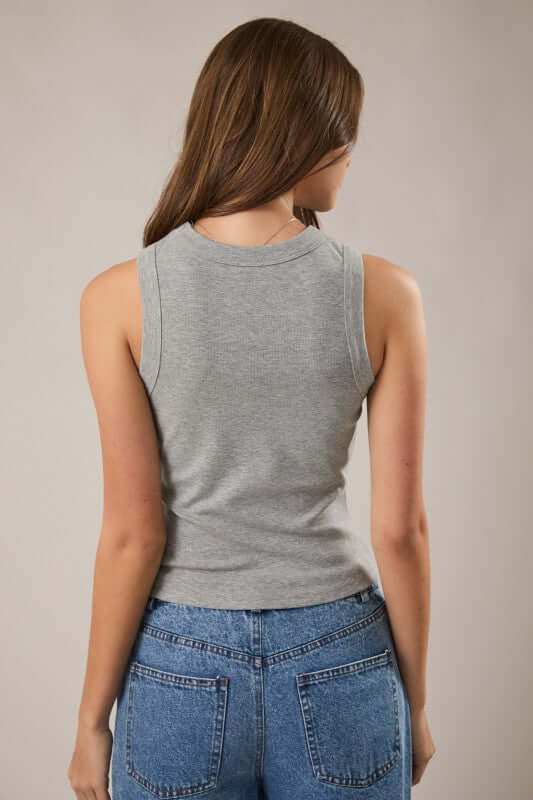 LE LIS sleeveless ribbed top in black, close-up view showing fitted sleeveless tank with textured rib fabric.