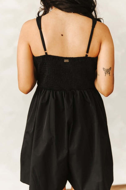 Black spaghetti strap mini dress by Lucky & Blessed featuring a horse snaffle buckle and cowgirl charm, perfect for stylish Western-inspired looks.