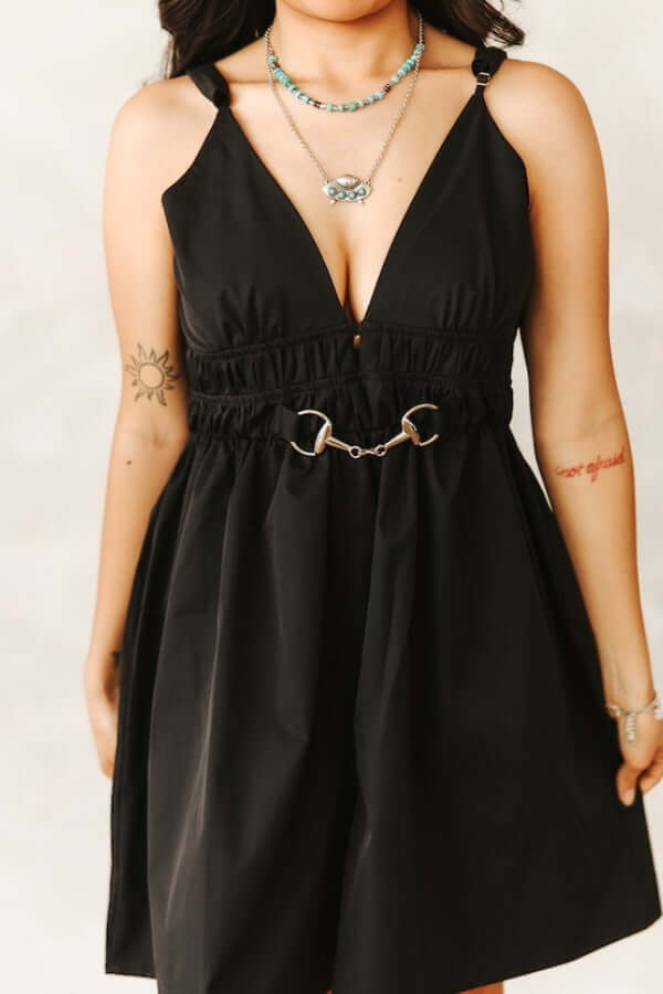 Black spaghetti strap cowgirl romper with horse snaffle buckle and Lucky & Blessed charm, perfect as a stylish mini dress.