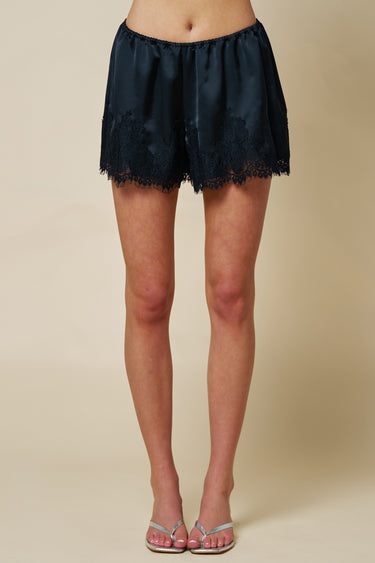 Blue Blush satin shorts with delicate lace trim, featuring a smooth fabric and stylish design for a comfortable fit.