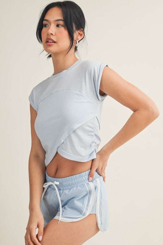Kimberly C crossover top featuring a stylish blouse with draped fabric and long sleeves, perfect for casual or office wear.