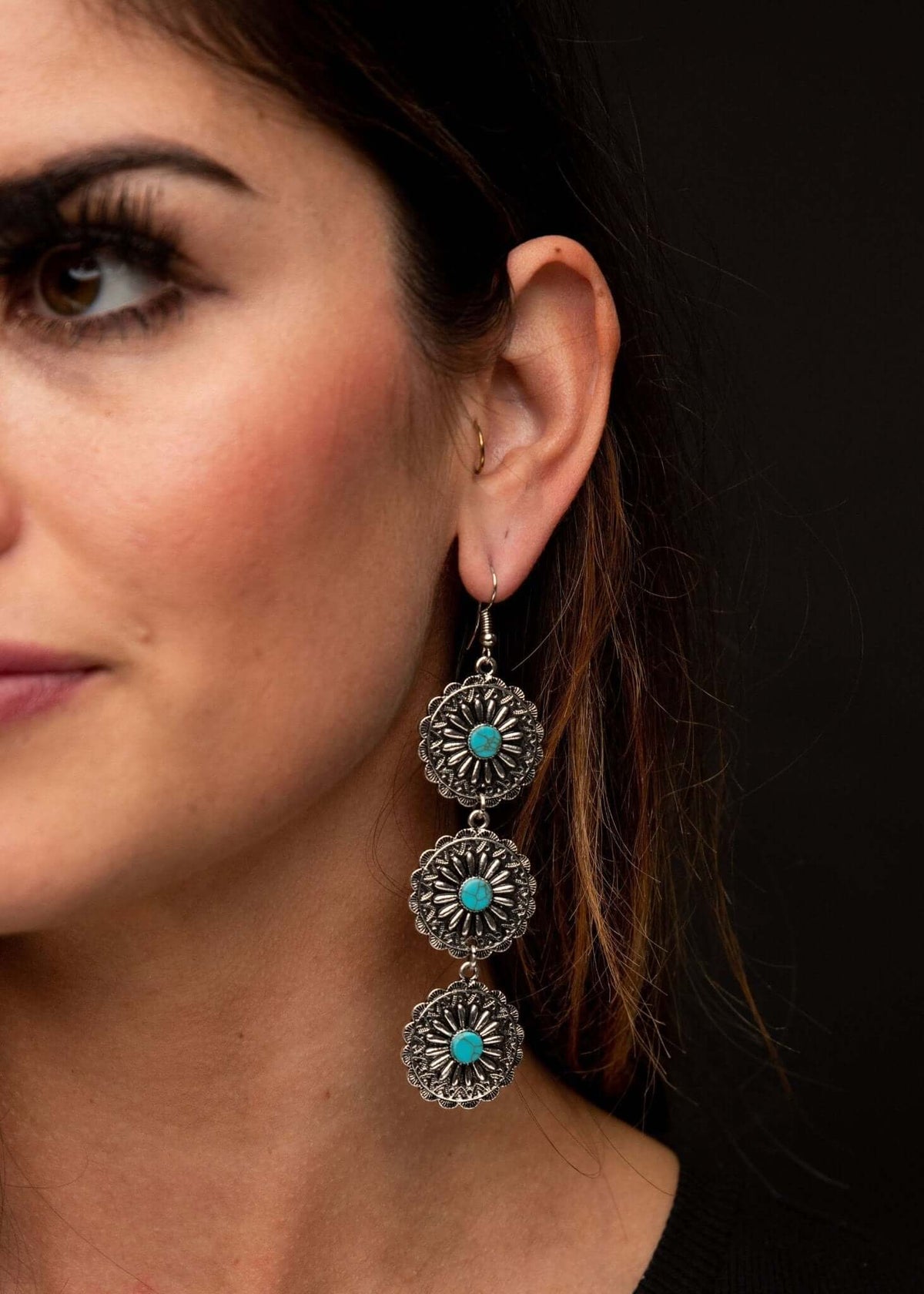 Three-tier burnished silver and turquoise flower concho ear jewelry by West & Co. featuring detailed floral design and silver accents.