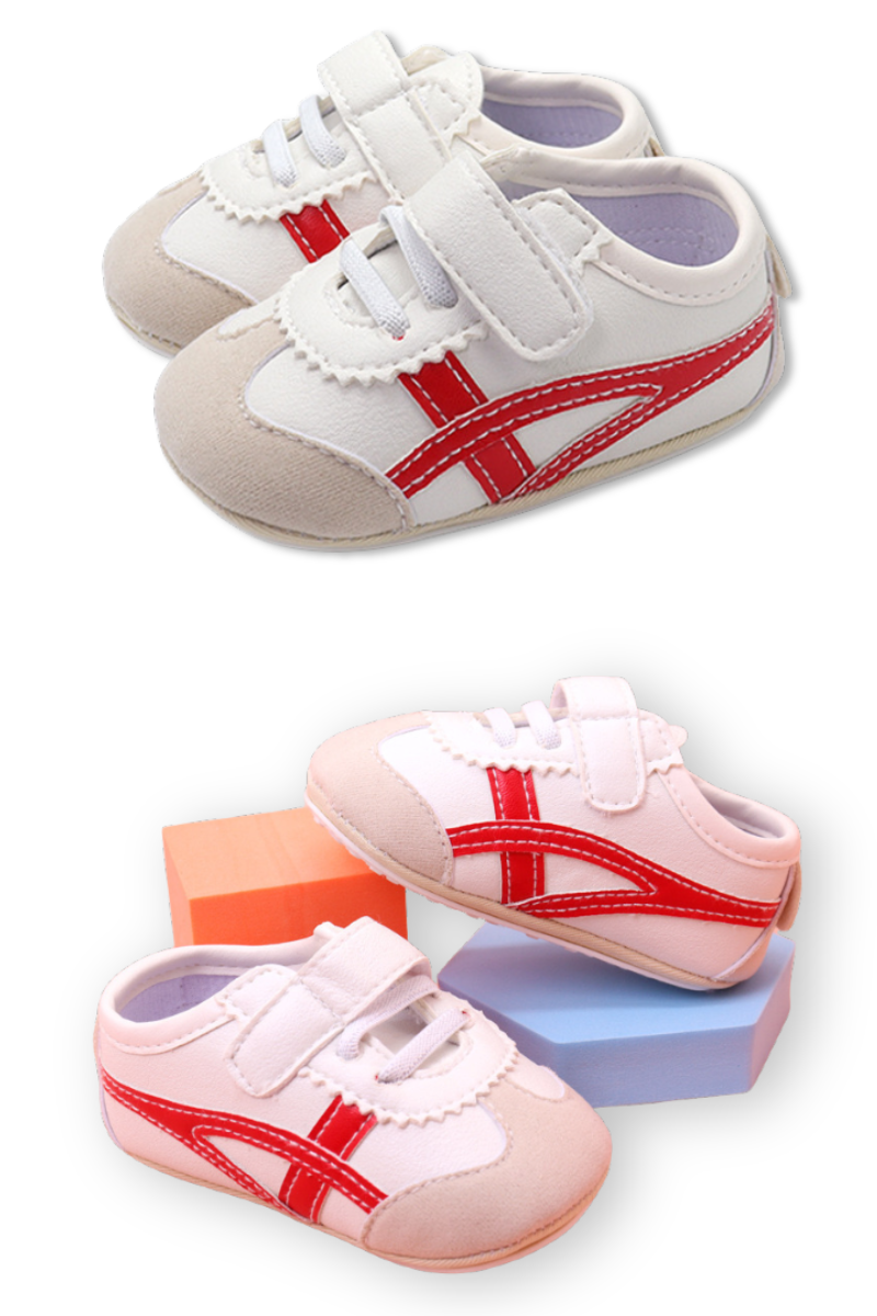Off white infant tennis shoes with red design
