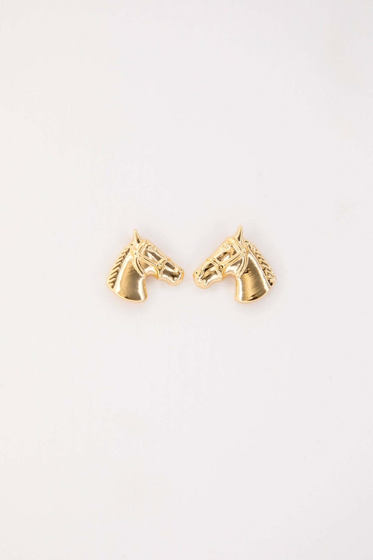 Gold plated horse head stud earring with burnished finish, crafted by West & Co., in a close-up view of the jewelry piece.