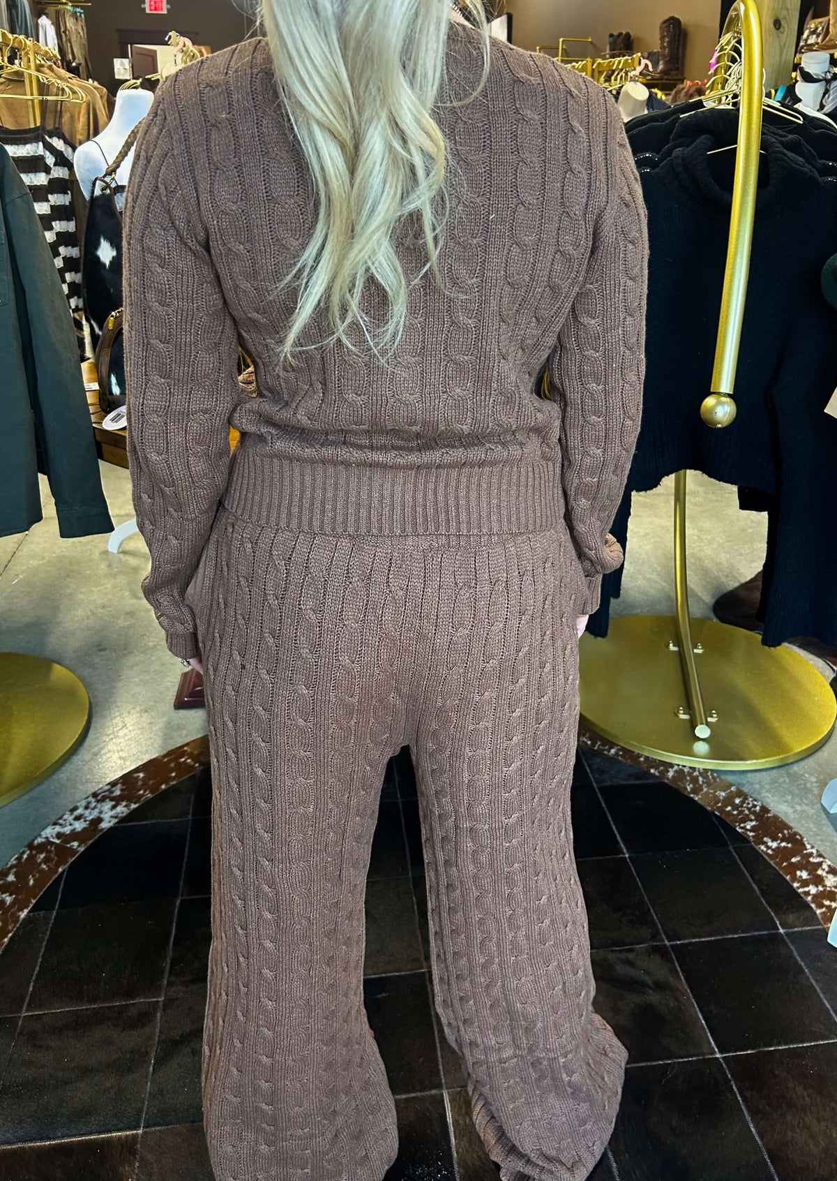 Bailey Rose cable knit wide-leg pants in neutral color, featuring a high waist and relaxed fit, displayed on a model.