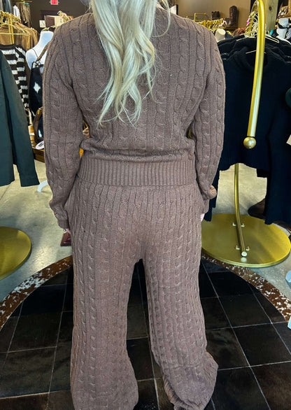 Bailey Rose cable knit wide-leg pants in neutral color, featuring a high waist and relaxed fit, displayed on a model.