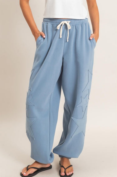 HYFVE Starstruck appliqué lounge pants in dusty blue, featuring a relaxed fit and star pattern design.