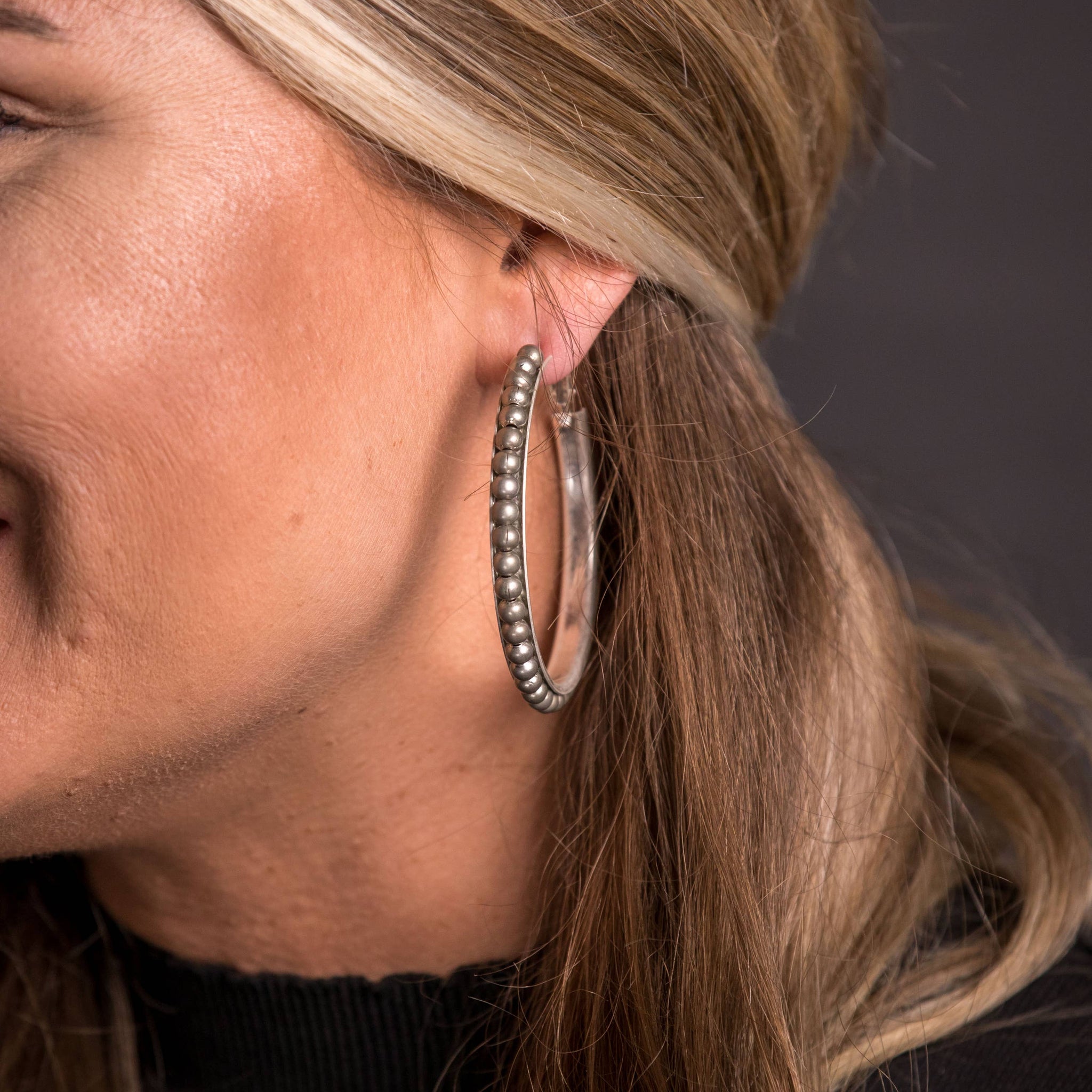 Worn Silver Trimmed Hoop Earring